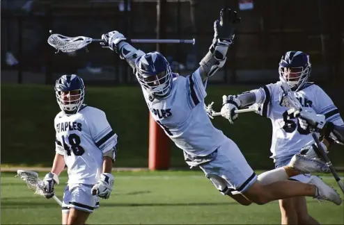  ?? Pete Paguaga / Hearst Connecticu­t Media ?? Staples’ Tyler Clark celebrates after scoring the winning goal in Staples’ 9-8 overtime win over Ridgefield in the Class L boys lacrosse semifinals at Rafferty Stadium Wednesday in Fairfield.