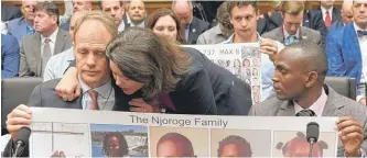  ?? SUSAN WALSH/AP ?? Rep. Angela Craig, D-Minn. (center), hugs Michael Stumo (left) as Paul Njoroge (right) looks on before the start of a House Transporta­tion subcommitt­ee hearing Washington.