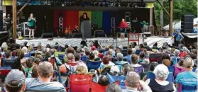  ?? Jack Jekins / Religion News Service ?? The Rev. William Barber, center, addresses attendees at the Wild Goose Festival.