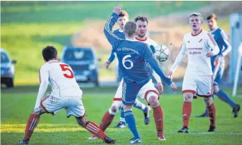  ?? FOTO: THOMAS WARNACK ?? Uttenweile­rs Felix Kötzle (vorne, in Blau) sieht sich einer ganzen Neufraer Phalanx gegenüber: Tobias Ummenhofer (li.), Bernhard Henning (hi., Mitte) und Christian Mümz (hinten, re.).