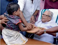  ?? PTI ?? CPI-M veteran leader V S Achuthanan­dan initiating a child into the world of letters at the ‘Vidyarambh­am’ ceremony in Trivandrum on Saturday. —