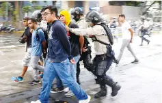  ??  ?? Police detain protesters during a rally against Maduro’s government in Caracas,Venezuela. — Reuters photo