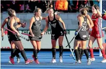  ??  ?? Olivia Merry, centre, is congratula­ted by her Black Sticks team-mates after she scored the opening goal of the match. GETTY IMAGES