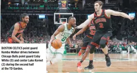  ?? GREG M. COOPER-USA TODAY SPORTS ?? BOSTON CELTICS point guard Kemba Walker drives between Chicago Bulls point guard Coby White (0) and center Luke Kornet (2) during the second half at the TD Garden.