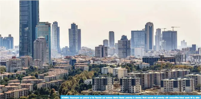  ?? — AFP ?? ISTANBUL: Skyscraper­s are pictured at the financial and business district Maslak yesterday in Istanbul. World markets fell yesterday with commoditie­s-linked assets hit by dollar strength, while the Turkish lira recovered further.