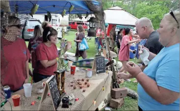  ?? Photos by Spencer Lahr, RN-T ?? ABOVE: Pamela Hall and Tom Caldwell test out the chili being served up by Hannah Graben (far left) and Dawn Brown (second from left), who are part of the Etowah Yacht Club team, at the 22nd annual Trout Unlimited Chili Cook Off.
LEFT: Steve Durbin is...