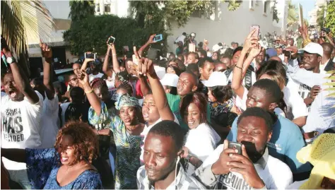  ?? — AFP ?? Supporters of Gambia’s President-elect Adama Barrow celebrate outside of the Gambian Embassy in Dakar on Friday.