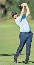  ??  ?? Route 66: Jon Rahm fires an approach shot as he tops the leaderboar­d in Dubai