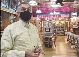  ?? ASSOCIATED PRESS ?? Griffith & Feil in Kenova, W.Va., with pharmacist Ric Griffith, 250 mom-and-pop pharmacies in West Virginia helping to residents in the quest to banish the Coronaviru­s pandemic. is among vaccinate