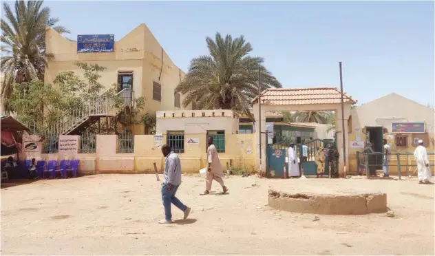  ?? Agence France-presse ?? People walk outside the Bashir Hospital ↑ in Khartoum on Friday.