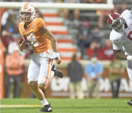  ?? CAITIE MCMEKIN/POOL PHOTO VIA NEWS SENTINEL ?? Tennessee quarterbac­k Brian Maurer, left, runs with the ball in the fourth quarter against Alabama Saturday at Neyland Stadium in Knoxville, Tenn.