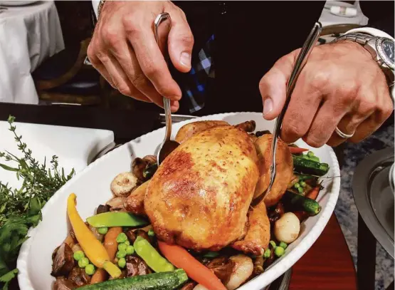  ?? Gary Fountain photos ?? The heritage free-range chicken for two, carved tableside, is an old-school joy at La Table.