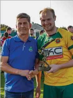  ??  ?? Wicklow League’s John Shea presents Rathnew’s Theo Smyth with the man of the match award from the 2020 Wicklow Cup final.