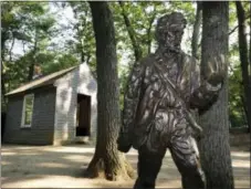  ?? MICHAEL DWYER — THE ASSOCIATED PRESS FILE ?? In this file photo, a statue of Henry David Thoreau stands outside a replica of his cabin near the shores of Walden Pond in Concord, Mass.