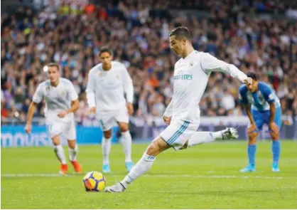  ?? Associated Press ?? Real Madrid’s Cristiano Ronaldo takes a penalty kick against Malaga during their Spanish League match at the Santiago Bernabeu Stadium in Madrid on Saturday.