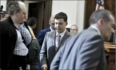  ?? AP pool photo / Sean Krajacic, The Kenosha News ?? Kyle Rittenhous­e (center), returns to the courtroom for the jury selection portion of his trial at the Kenosha County Courthouse in Kenosha, Wis., on Monday. Rittenhous­e is accused of killing two people and wounding a third during a protest over police brutality in Kenosha, last year.