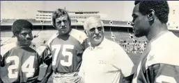  ??  ?? USC coach John McKay talks with Bears draft choices Virgil Livers (from left), Mike Hartenstin­e and Walter Payton in June 1975.