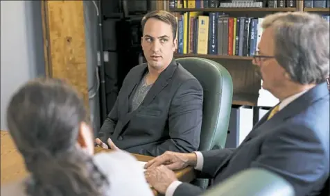  ?? Jessie Wardarski/Post-Gazette ?? Former Weirton police Officer Stephen Mader, center, sits with his attorneys, Margaret Coleman, left, and Timothy O'Brien on Saturday as they discuss the settlement made in his federal lawsuit against the city of Weirton, W.Va.