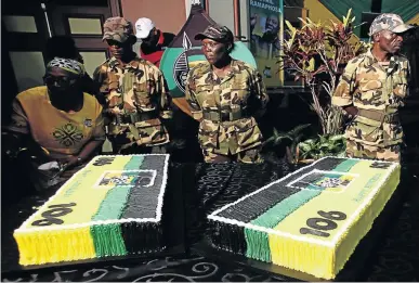  ?? /MASI LOSI ?? Members of the MKVA form a guard next to ANC’s 106th birthday cake.