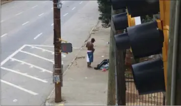  ?? ROBERT RAY — THE ASSOCIATED PRESS FILE ?? Homeless men on a sidewalk outside a shelter in Atlanta. Volunteers who feed the homeless in public places say they’re providing a needed service. But city government­s and some advocates say their well-meaning efforts can hinder long-term solutions and...