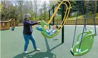  ?? KIM HAIRSTON/ THE BALTIMORE SUN ?? Cathy Szydlowski of Bel Air gives her grandson, Elliott Warner, 4, a push in a swing at Lyn Stacie Getz Creative Playground.The playground was partially designed by children.