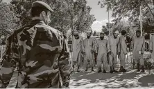  ?? Jim Huylebroek / New York Times file ?? Taliban prisoners are lined up at the Bagram military base in Afghanista­n before being released on May 26.