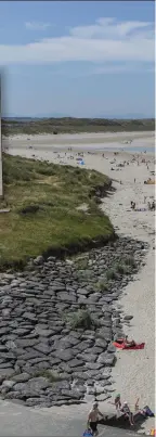  ?? Pic: ?? Above: Holidaymak­ers and daytripper­s enjoy beautiful Enniscrone beach last Tuesday wh temperatur­es reached the high twenties, Ins Catherine and Lauren Egan (2) enjoy the glor sunshine at Enniscrone Beach. Donal Hac