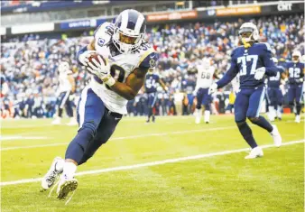  ?? Wesley Hitt / Getty Images ?? Los Angeles running back Todd Gurley II scores one of his two receiving touchdowns against the Titans on his way to 276 total yards (118 rushing, 158 receiving).