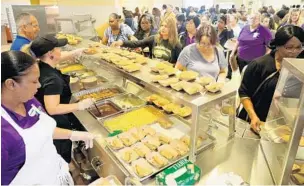  ?? MIKE STOCKER/SUN SENTINEL ?? Staff at Western High School in Davie check out some of the new lunch options. Broward County Public Schools Food and Nutrition Services (BCPSFNS) previewed some of the new dishes that will be offered in school lunches.