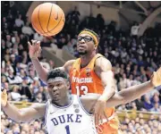  ?? [AP PHOTO] ?? Duke’s Zion Williamson (1) and Syracuse’s Paschal Chukwu struggle for possession during overtime Monday in Durham, N.C.