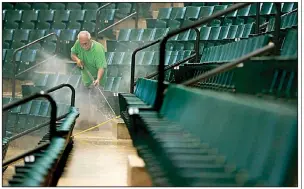  ?? The Northeast Mississipp­i Daily Journal/THOMAS WELLS ?? Carolina Cleaner employee David Hill continues power washing the risers and seats at the BancorpSou­th Arena in Tupelo, Miss., as they prepare the site for new seats around the upper bowl in early July.