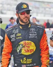  ?? THE ASSOCIATED PRESS FILE ?? Martin Truex Jr. walks to his car on pit road during qualifying for the NASCAR Cup Series race at Daytona last weekend. He will be on the pole for tonight’s race at Kentucky Speedway.