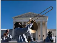  ?? (AP/Alex Brandon) ?? A band performs Tuesday for protesters gathered in front of the U.S. Supreme Court as arguments are heard about the Patient Protection and Affordable Care Act.