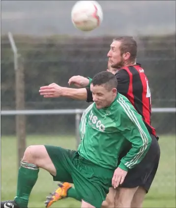  ??  ?? Bellurgan’s Ray Finnegan wins a high ball against Duleek striker Barry Kavanagh.