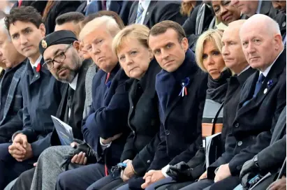  ?? AFP ?? (From left) Canadian Prime Minister Justin Trudeau, Morocco’s King Mohammed, US First Lady Melania Trump, US President Donald Trump, German Chancellor Angela Merkel, French President Emmanuel Macron and wife Brigitte Macron, Russian President Vladimir Putin and Australian Governor-General Peter Cosgrove at the Arc de Triomphe in Paris. —