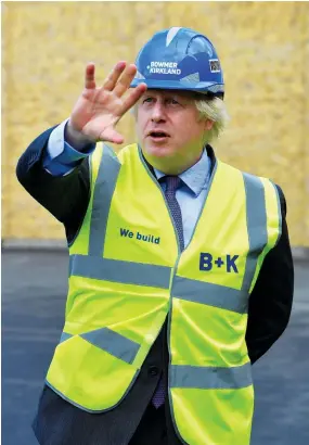  ?? AFP ?? We really want to build back better, to do things differentl­y. Boris Johnson Prime minister of Britain
Britain’s Prime Minister Boris Johnson visits the constructi­on site of Ealing Fields High School in
London on Monday.