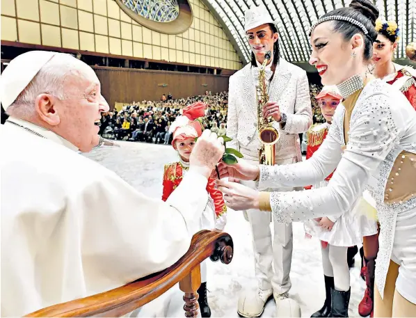  ?? ?? Pope Francis is greeted by Ukranian dancers at his weekly audience at the Vatican where he condemned recent missile attacks on Iraqi Kurdistan – as well as sharing his observatio­ns on the pleasures of sex