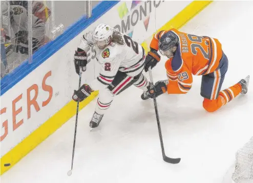  ?? CODIE MCLACHLAN/AP ?? Duncan Keith, pursued by Edmonton’s Leon Draisaitl, played well in Game 1 but struggled mightily Monday in Game 2 against the Oilers.
