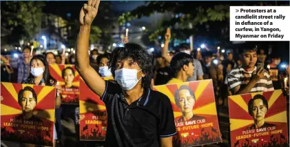  ??  ?? Protesters at a candlelit street rally in defiance of a curfew, in Yangon, Myanmar on Friday