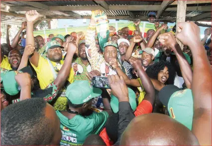  ?? - Picture by Kudakwashe Hunda ?? ZANU-PF supporters celebrate the revolution­ary party’s resounding victory during the 2018 harmonised elections at the party’s Magaba office in Mbare, Harare, last week. Cde Martin Sununguray­i Matinyanya (raising scarf) won the Mbare council seat.