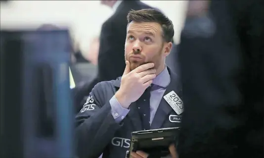  ?? Spencer Platt/Getty Images ?? Traders work on the floor of the New York Stock Exchange moments before the closing bell Thursday in New York City. As Wall Street continues to worry about future inflation and rising interest rates, the Dow fell more than 1,000 points for the second...