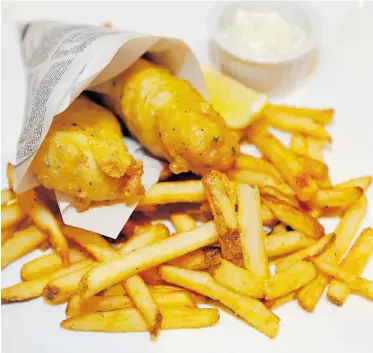  ?? ED KAISER/ EDMONTON JOURNAL ?? Fish and chips are a crispy indulgence at the L1 lounge at the Fantasylan­d Hotel.