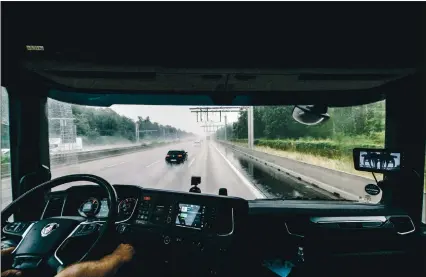  ?? PHOTOS: FELIX SCHMITT — THE NEW YORK TIMES ?? A truck draws electric power from overhead wires as it is driven along three miles of highway south of Frankfurt, Germany, last month. The idea is to test the system through everyday use by real trucking companies to help curb greenhouse gasses emitted by regular trucks.