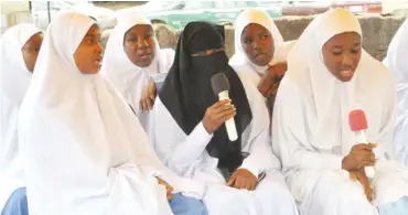  ?? Photo: Abubakar Yakubu ?? Women recite some verses of the Holy Quran at a Walimat graduation ceremony in Abuja recently