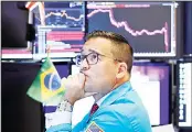  ??  ?? Specialist Paul Cosentino works on the floor of the
New York Stock Exchange on Aug
5. US stocks opened higher on Tuesday, with the battered technology stocks providing the biggest boost, as China
stepped in to stabilize the yuan.
(AP)