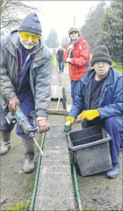  ?? Picture: CDMES ?? Canterbury & District Model Engineerin­g Society members Dave Pearson and Andy Dale busy clearing the trackbed ready for the installati­on of new track