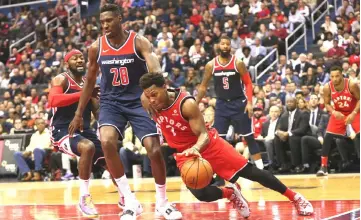  ??  ?? Toronto Raptors guard Kyle Lowry (front) dribbles the ball as Washington Wizards center Ian Mahinmi defends in the second quarter at Capital One Arena. — USA TODAY Sports photo