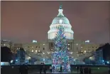  ?? Associated Press ?? The U.S. Capitol Christmas Tree at night after negotiator­s sealed a deal for COVID relief Sunday. The sweeping $900 billion pandemic relief package that Congress has approved contains billions in aid directed specifical­ly at struggling small businesses.