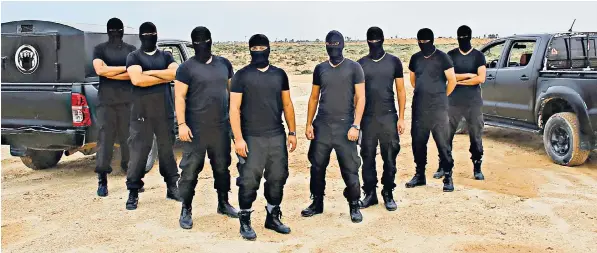  ??  ?? The Specialise­d Interventi­on Squad, also known as the ‘Masked Men’, were originally set up as a volunteer police unit, but now find themselves the main crime-fighting force in Zuwara, western Libya