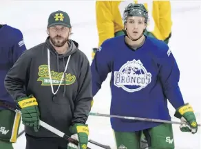  ?? JONATHAN HAYWARD/THE CANADIAN PRESS ?? Broncos player Brayden Camrud and head coach Nathan Oystrick take part in a practice Tuesday.